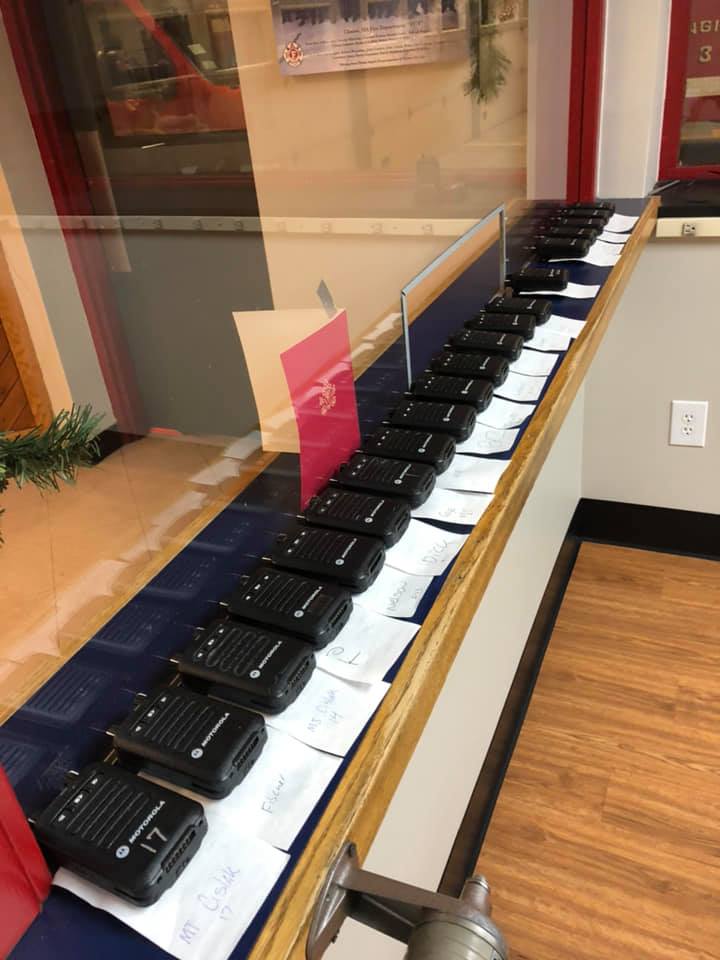 a line of handheld radios on a desk