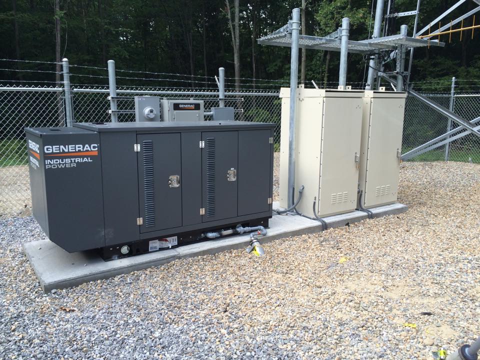 a radio tower power source during the day inside a fence