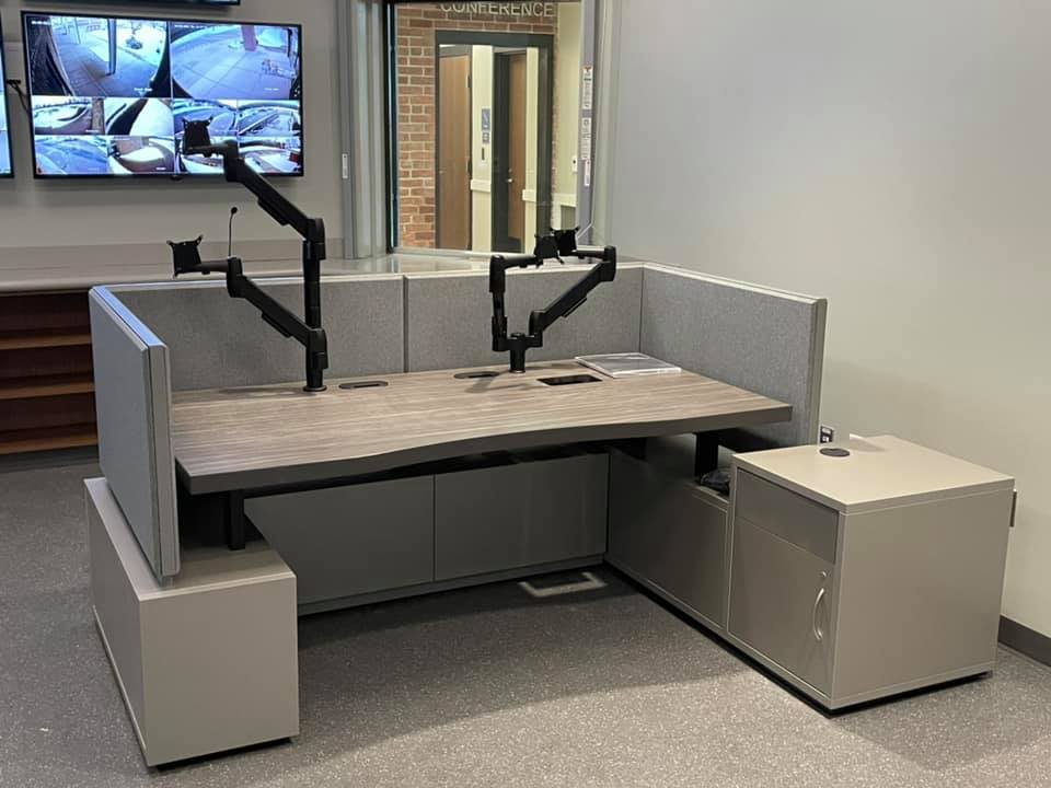 a desk with many monitor mounts